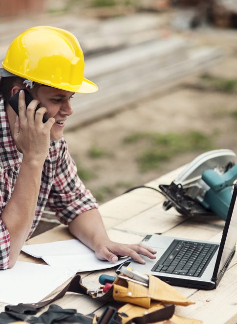 Carpenter talking on mobile phone
